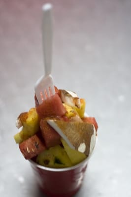 The cup of fruit pico de gallo with salt, chili powder ...